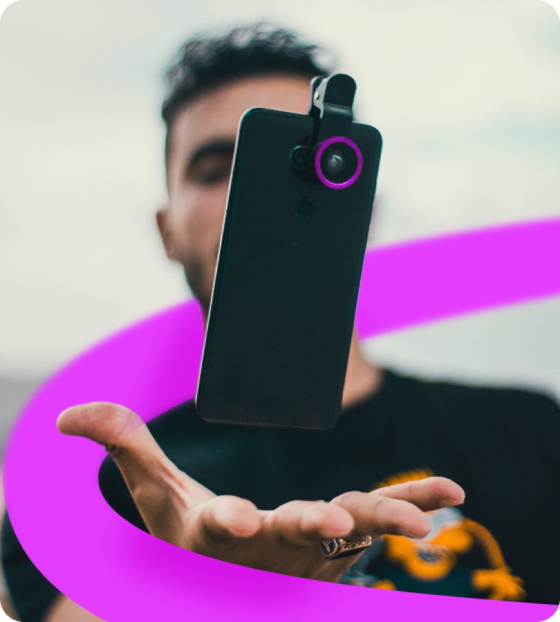 A man holding a phone with a pink circle surrounding him